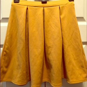 Mustard colored pleated mini skirt